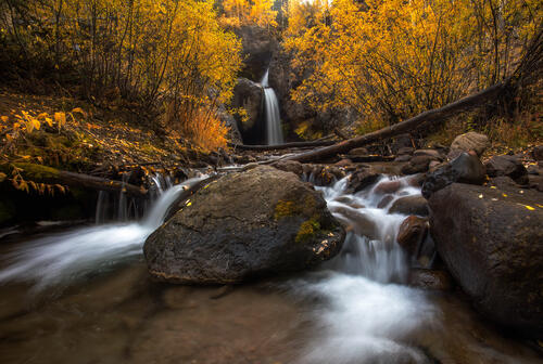 Autumn waterfall and boulders