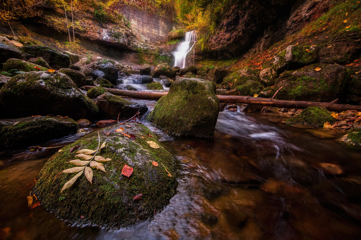 Autumn waterfall and mossy rocks