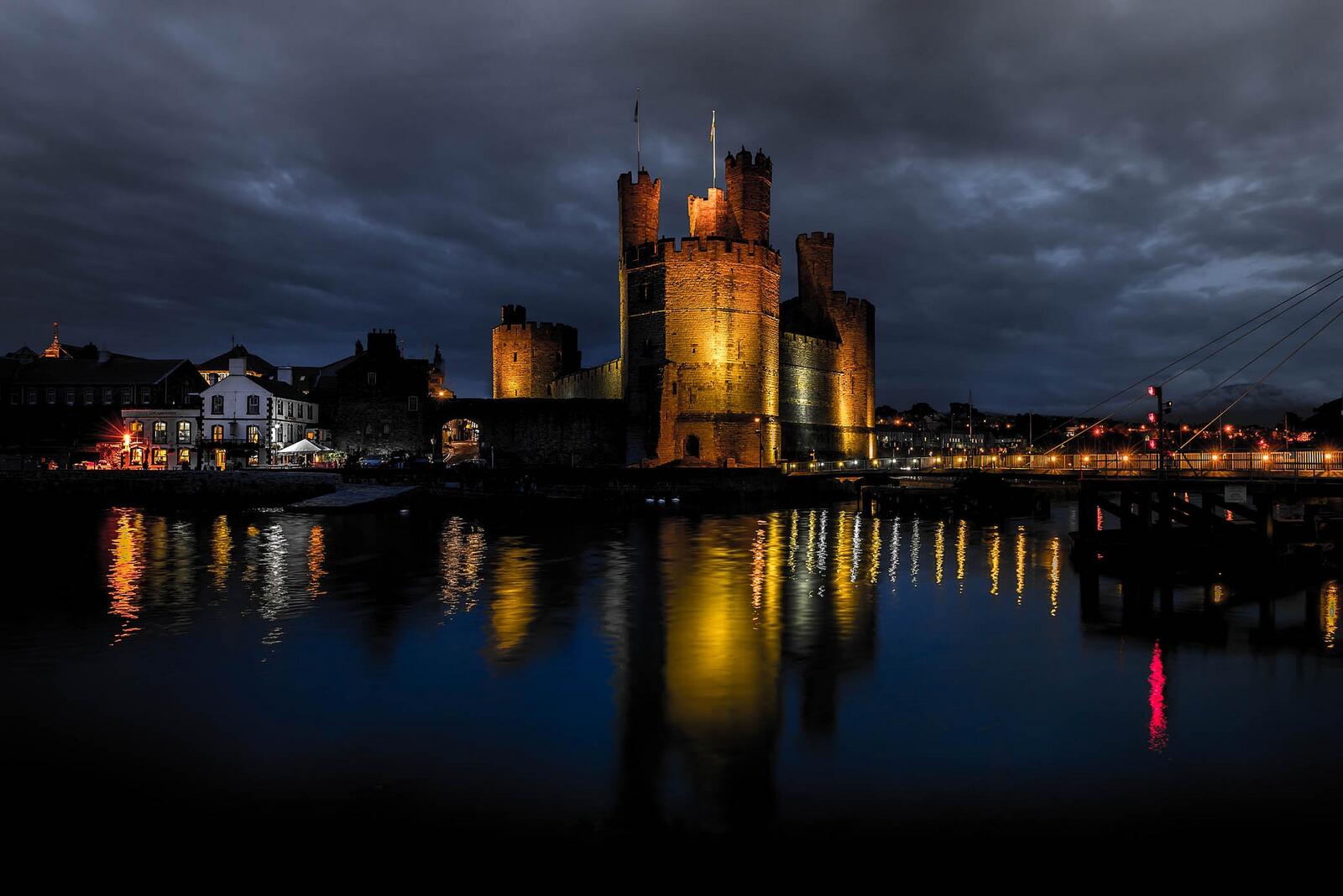 Wallpapers The Caernarfon castle a medieval castle located in the town of Carnarvon the County Gwynedd region of Wales on the desktop