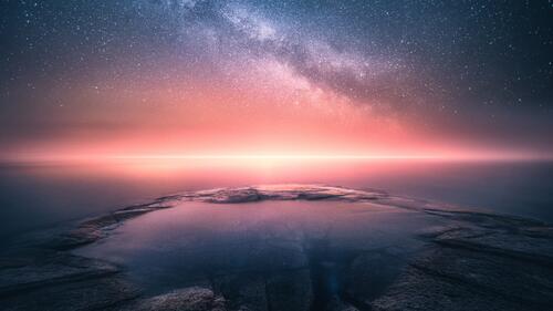Starry sky at sunset by the sea