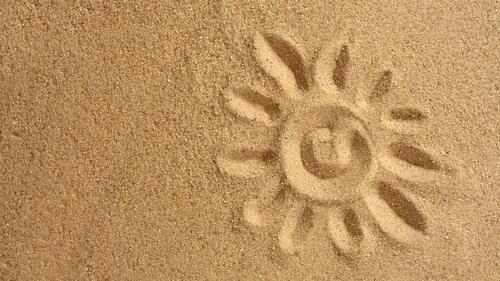 Drawing sun on the sand