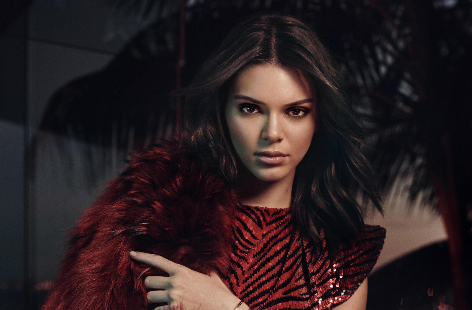 Free photo Kendall Jenner in a dress by a palm tree