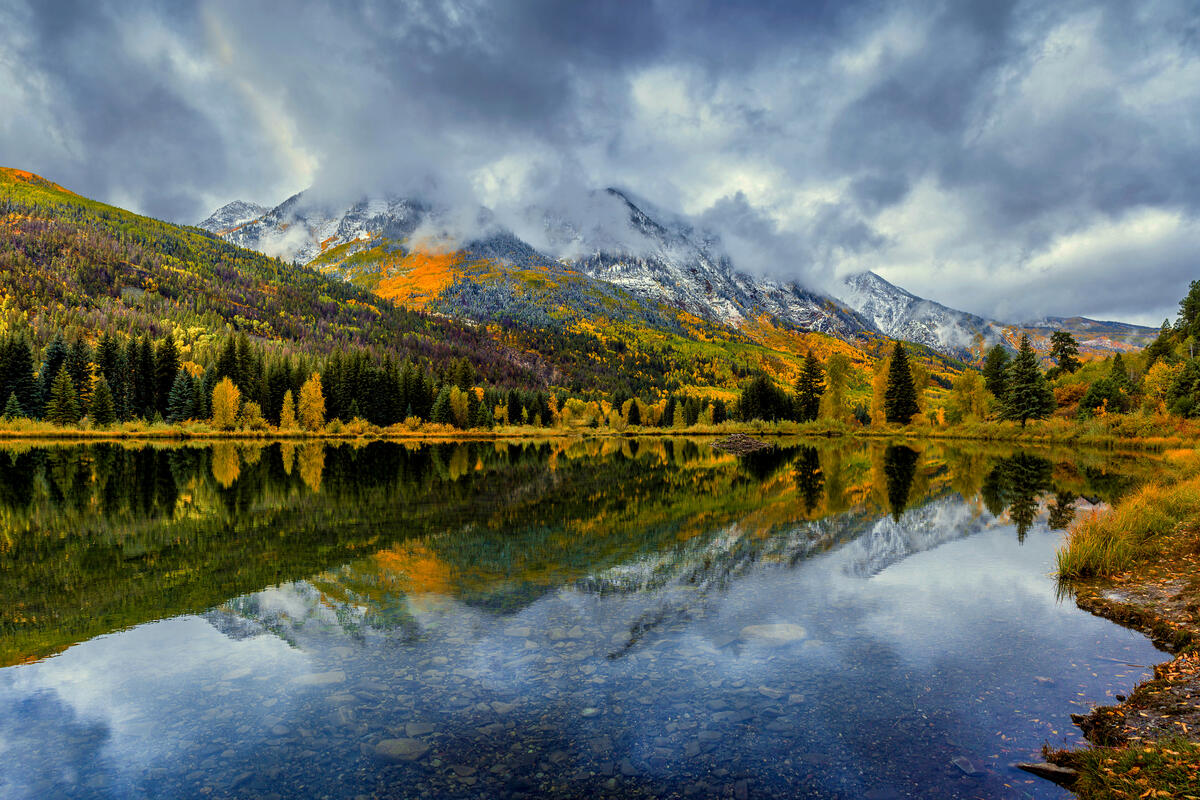 Reflection of autumn forest in a mountain lake