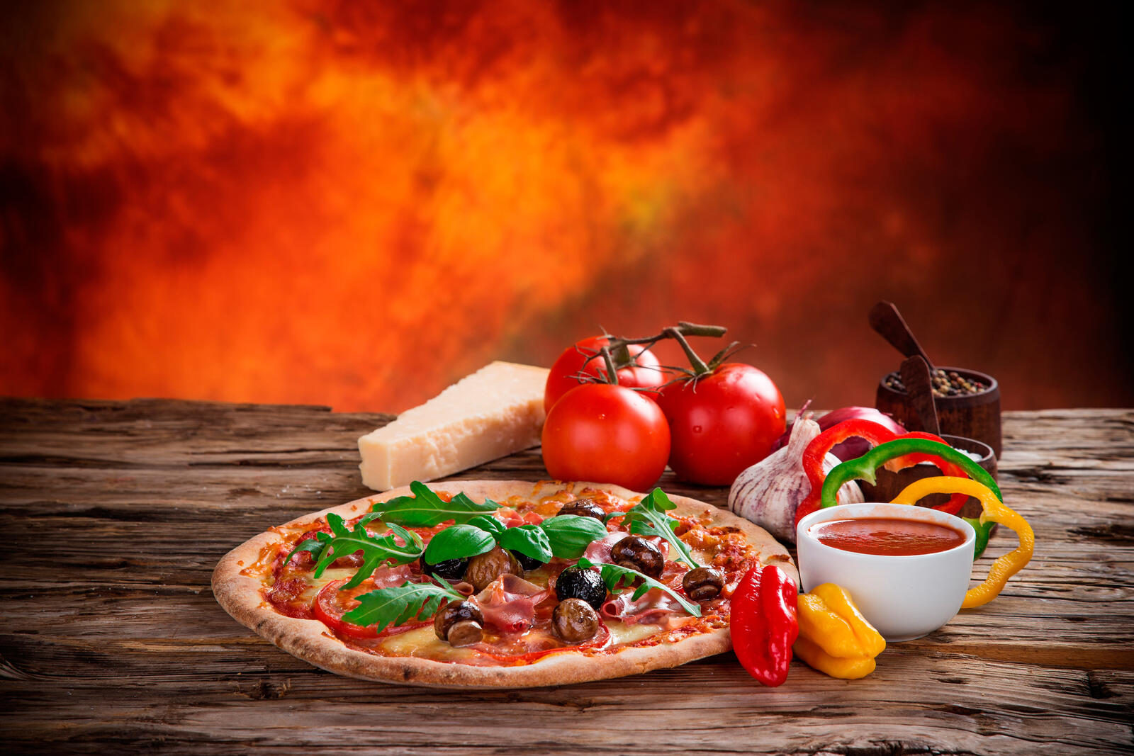 Free photo Pizza on a fiery background