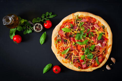 Red pizza on a dark background
