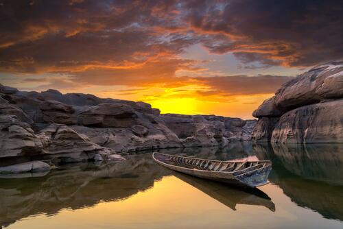 Rocks, boat and sunset