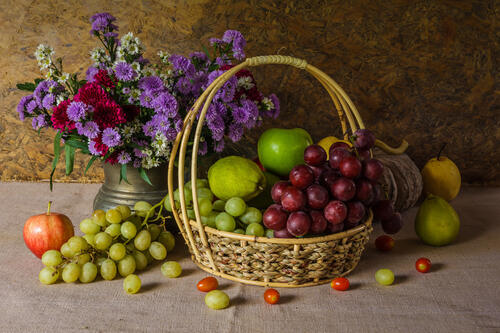 Bouquet and fruits in a basket