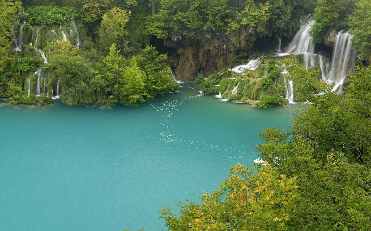 Waterfalls into a blue lake